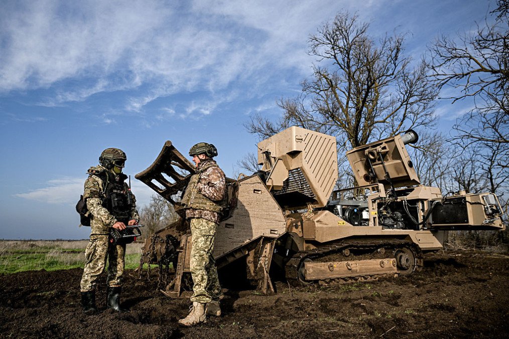 Servicemen of the 808th Dniester Separate Support Brigade of the Ukrainian Armed Forces work beside a GCS-200 explosive hazard-clearance machine during demining operations on a liberated territory in Kherson region, Ukraine, (Source: Getty Images)