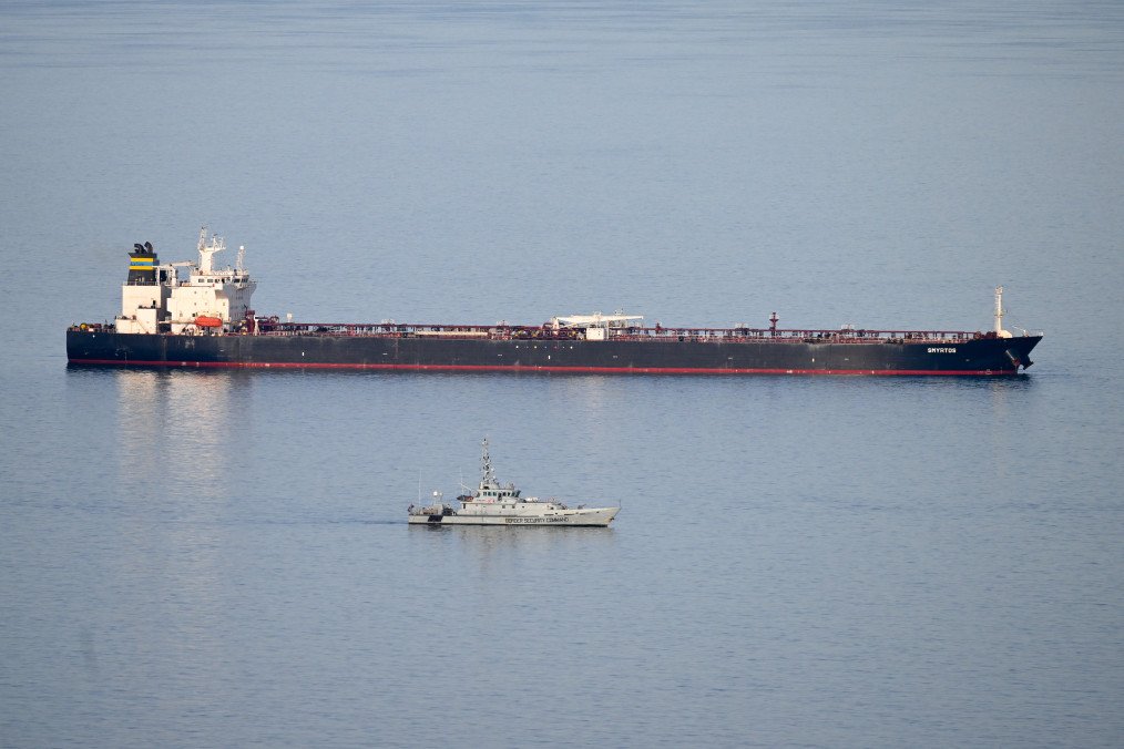 Military ships patrol the Smyrtos vessel outside the harbour, on June 14, 2026, in Portland, England.