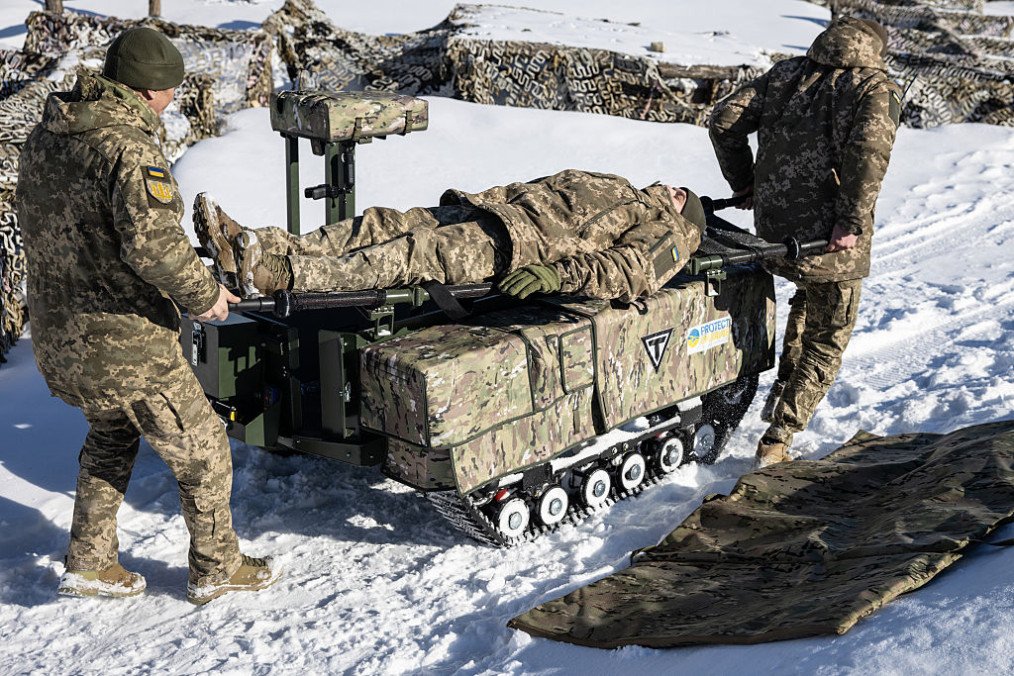 Soldiers demonstrate how the Tencore Unmanned Ground Vehicle (UGV) TerMIT is used for evacuation procedures during a demonstration on February 20, 2026 in Kyiv Region, Ukraine. (Source: Getty Images) Soldiers demonstrate how the Tencore Unmanned Ground Vehicle (UGV) TerMIT is used for evacuation procedures during a demonstration on February 20, 2026 in Kyiv Region, Ukraine. (Source: Getty Images)