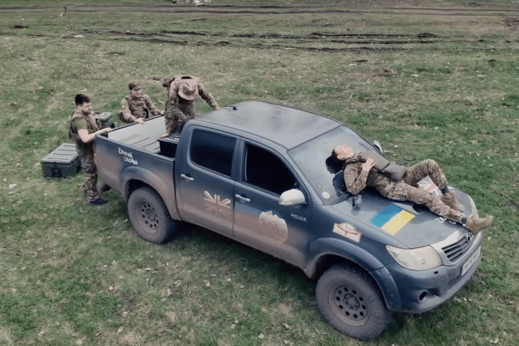 Ukrainian service members rest and prepare equipment around a Toyota Hilux provided by the Driving Ukraine initiative. (Source: First Separate Medical Battalion/Instagram)