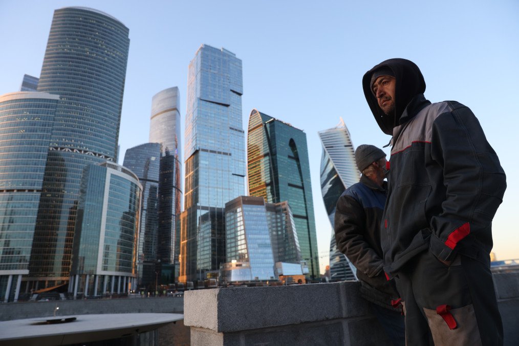 Central Asian migrants, working at the construction site of a pier for touristic ships, stand opposite the Moscow International Business Center (MIBC), also known as Moscow City, April 5, 2024, in Moscow, Russia. (Source: Getty Images)