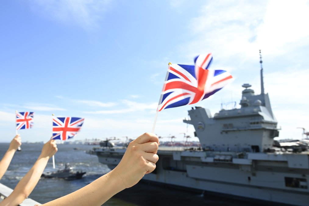 People with the UK national flag greet the Royal Navy’s flagship aircraft carrier, HMS Prince of Wales, departing Tokyo, Japan, on September 2, 2025. (Source: Getty Images) People with the UK national flag greet the Royal Navy’s flagship aircraft carrier, HMS Prince of Wales, departing Tokyo, Japan, on September 2, 2025. (Source: Getty Images)