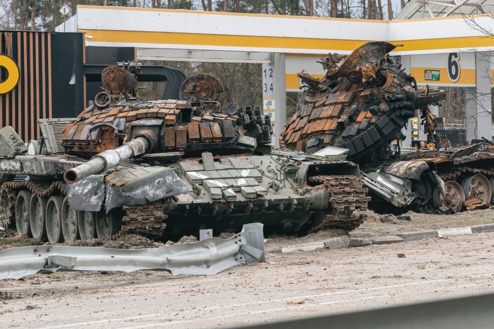 Two destroyed Russian tanks marked with the Russian military symbol “V” stand on the scene of hostilities at a damaged gas station on April 6, 2022, in the Kyiv region, Ukraine. (Source: Getty Images)