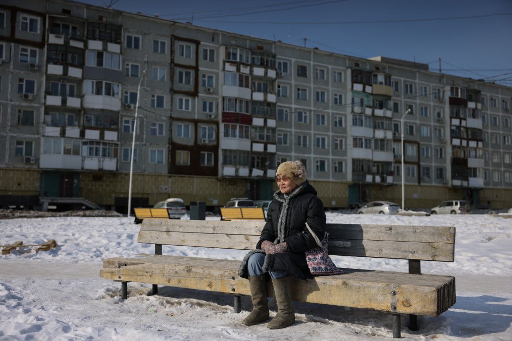 An elderly woman sits on a bench in Yakutsk on March 28, 2025. (Source: Getty Images)