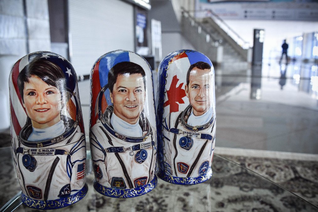 Russian traditional wooden dolls "matryoshka" depicting NASA astronaut Anne McClain, Russian cosmonaut Oleg Kononenko and David Saint-Jacques of the Canadian Space Agency. (Source: Getty Images)