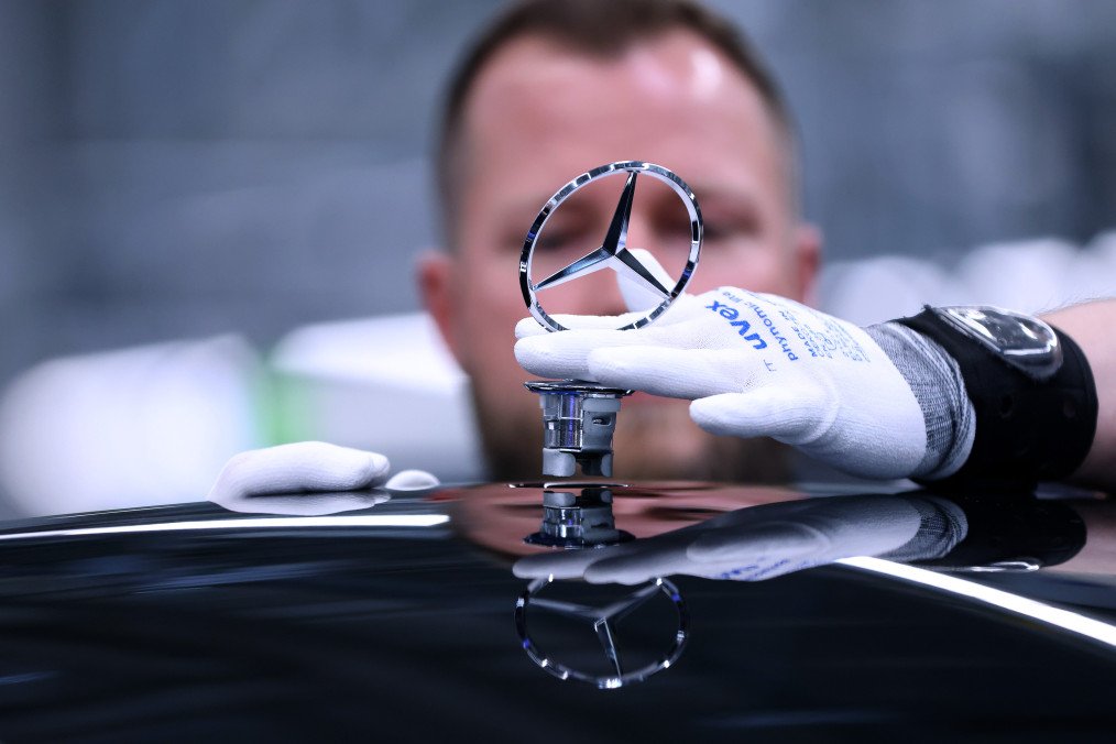 Defense Giant KNDS Eyes Mercedes Factory to Boost European Armor Production A worker fits a Mercedes Benz hood ornament on the assembly line of the Mercedes-Maybach S-class. (Source: Getty Images)