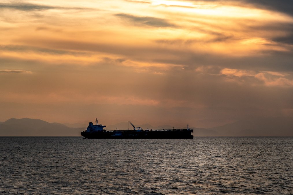Crude oil tanker in the sea at sunset. (Source: Getty Images)