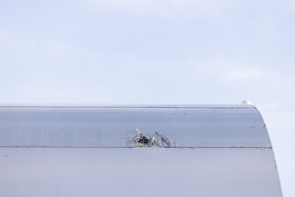 Damaged New Safe Confinement over Reactor 4 at the Chornobyl Nuclear Power Plant following a Russian drone strike. (Source: Getty Images)