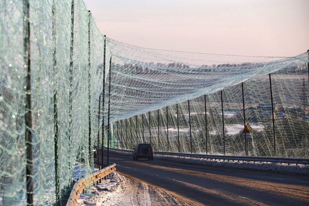 Cars move along a road covered with an anti-drone net in the Kharkiv region, on February 2, 2026. (Source: Getty Images)