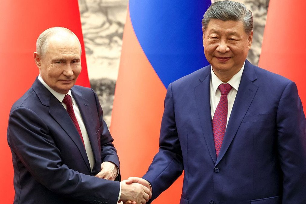 Russia’s leader Vladimir Putin and China’s President Xi Jinping shake hands during a signing ceremony following their talks in Beijing on May 20, 2026. (Source: Getty Images)