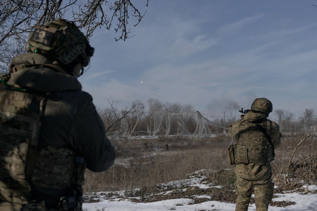 Anti-drone netting covers a supply route near Kostyantynivka in Ukraine’s Donetsk region, February 2026. Burned military vehicles are seen along the road amid ongoing Russian drone attacks. (Source: Getty Images)