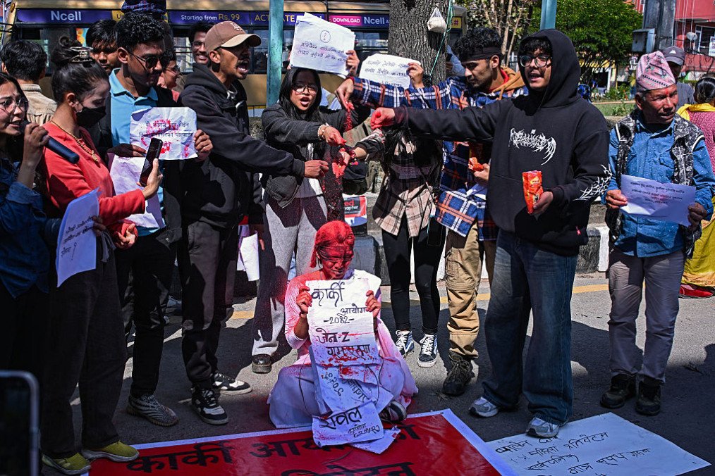 Activists in Kathmandu spatter red powder symbolizing blood to demand the release of the government’s inquiry report on Nepal’s September 2025 youth uprising. (Source: Getty Images)