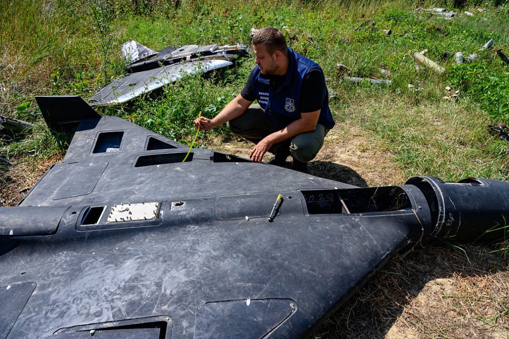 Dmytro Chubenko of the Kharkiv regional prosecutor’s office examines the carbon fiber remains of a Russian-made, Iran-designed Shahed-136 drone. (Source: Getty Images)