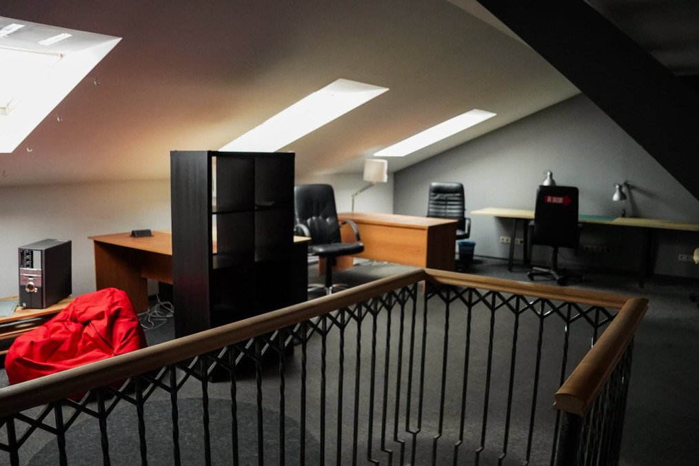 An upper-floor office area with multiple desks and skylights in the confiscated apartment. (Source: State Property Fund of Ukraine)