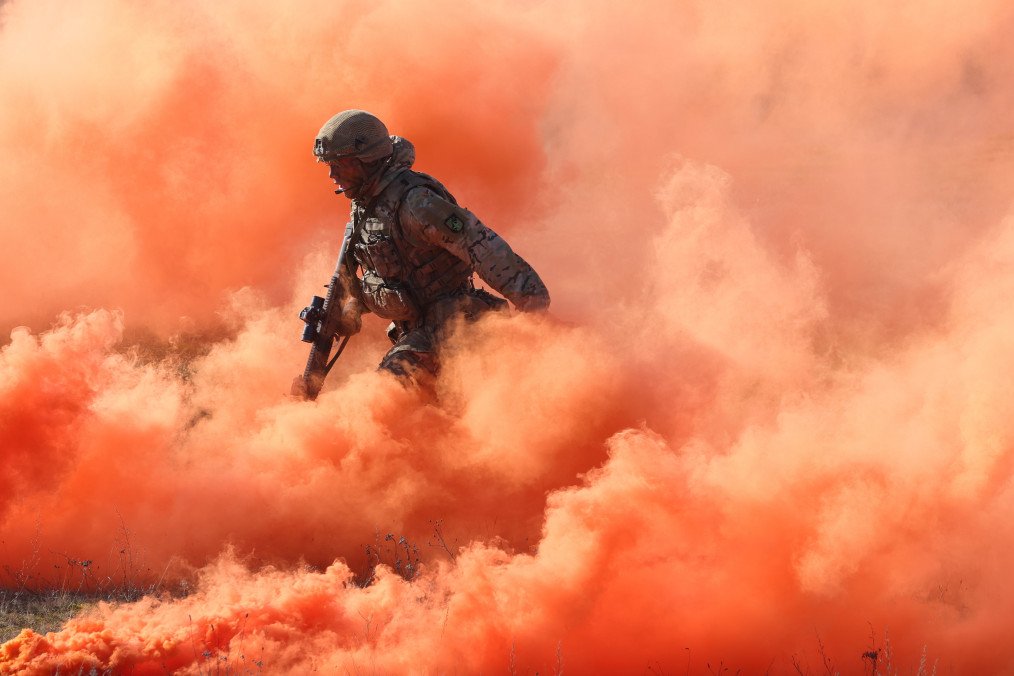 A soldier of the United Kingdom's 2nd Battalion Royal Anglian infantry unit storms an enemy position in a simulated attack during the NATO "Brilliant Jump" military exercises on February 26, 2024, in Drawsko Pomorskie, Poland.
