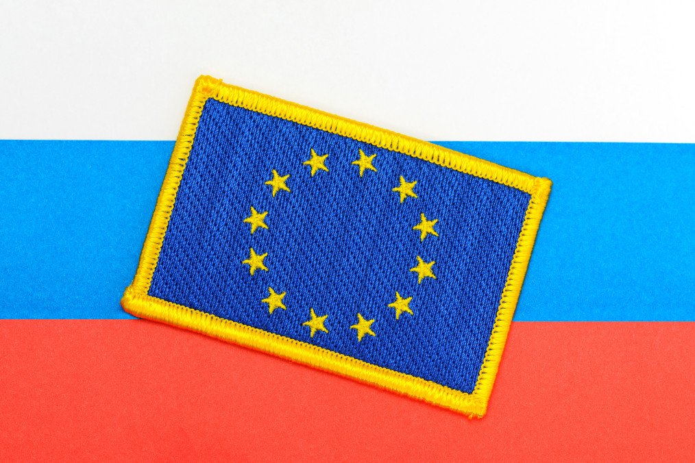 A patch of the European Union flag rests on the background of the Russian national flag. (Source: Getty Images)