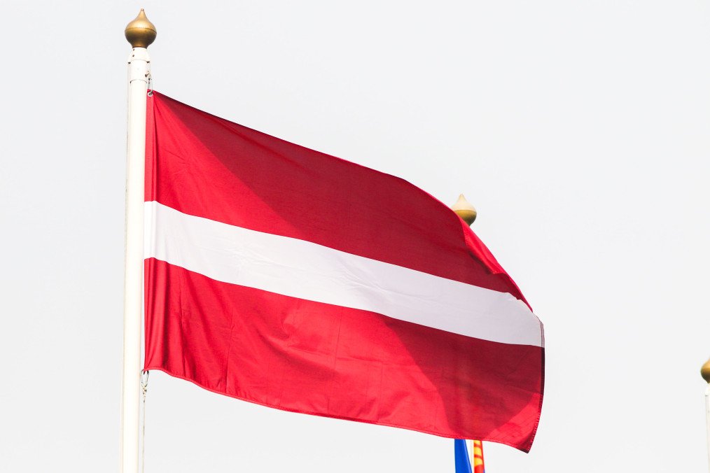 The flag of Latvia seen in the gallery of flags of the participating countries in the framework of St. Petersburg International Gas Forum 2022. Illustrative photo. (Source: Getty Images)