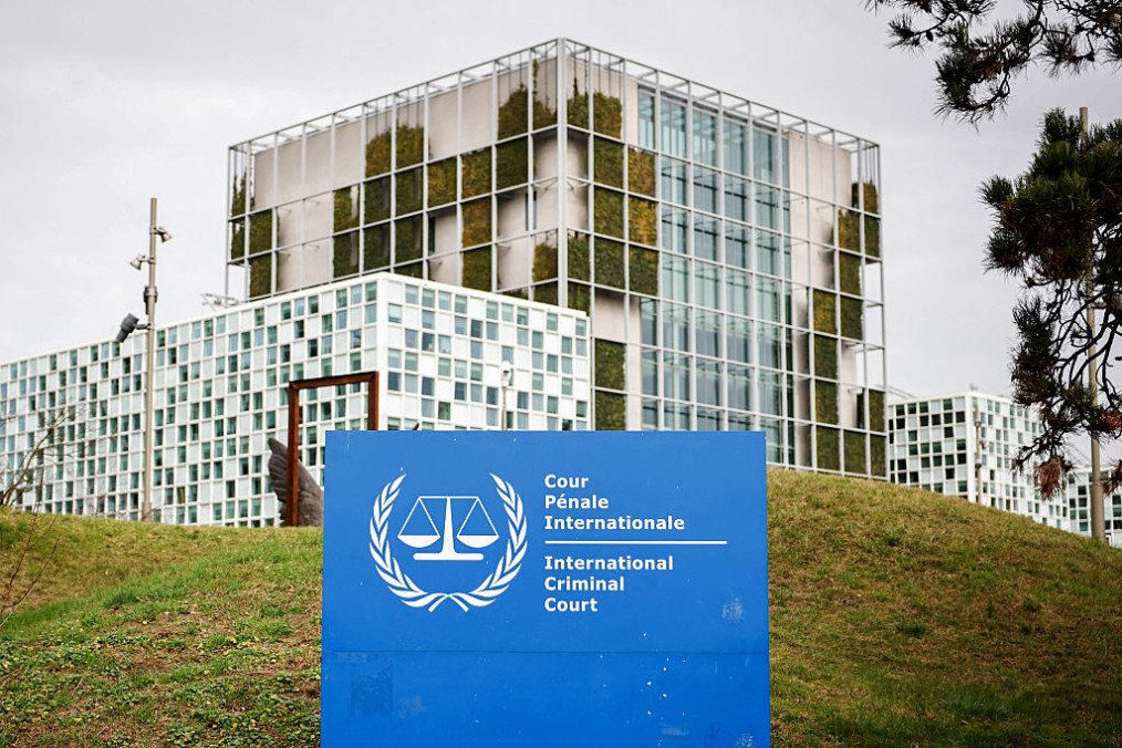 This photograph shows the “the International Criminal Court (ICC)” in the background with its logo on a sign in the foreground in The Hague, on February 23, 2026. (Source: Getty Images) This photograph shows the “the International Criminal Court (ICC)” in the background with its logo on a sign in the foreground in The Hague, on February 23, 2026. (Source: Getty Images)