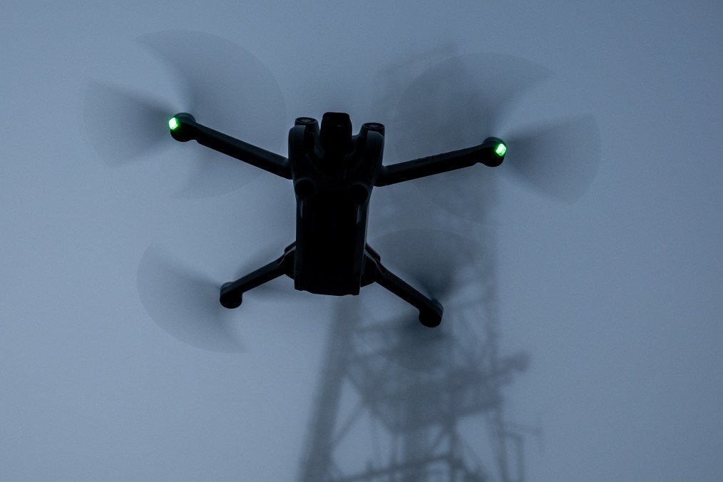 Russia Systematically Deploys FPV Drones as Weapons of Terror Against Ukrainian Civilians A DJI Mini 3 drone flies above the ground. (Source: Getty Images)