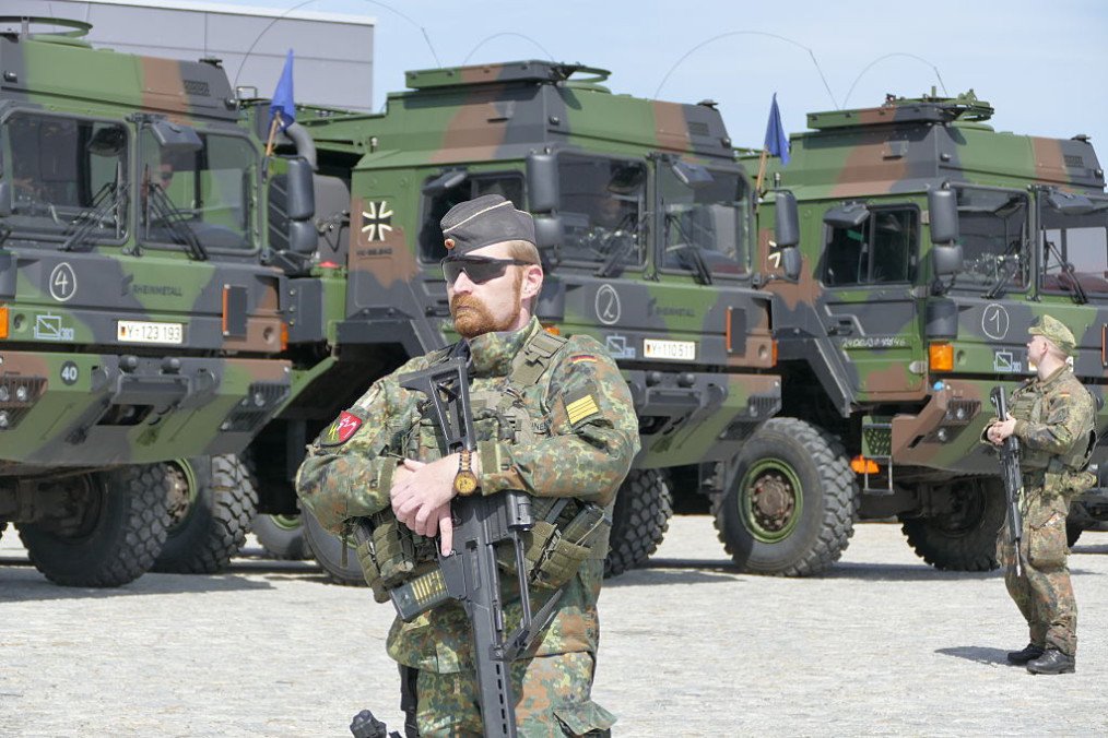 Soldiers stand on the grounds of the Breitenworbis highway maintenance depot in Thuringia, Germany, during a transnational Bundeswehr exercise. (Source: Getty Images)