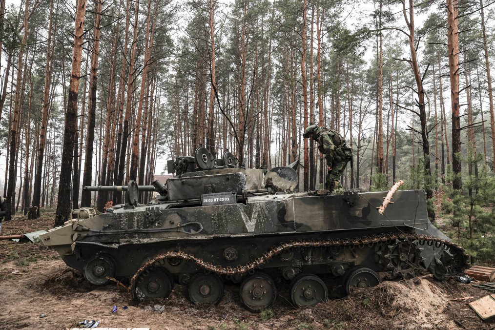 A Russian BMD seized inside the woodland is examined by Ukrainian soldiers in Irpin, Ukraine, on April 01, 2022. (Source: Getty Images)