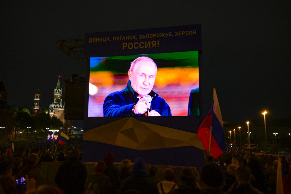 Russian leader Vladimir Putin is seen on a screen as he addresses a rally and a concert marking the annexation of four regions of Ukraine in central Moscow on September 30, 2022. (Source: Getty Images)