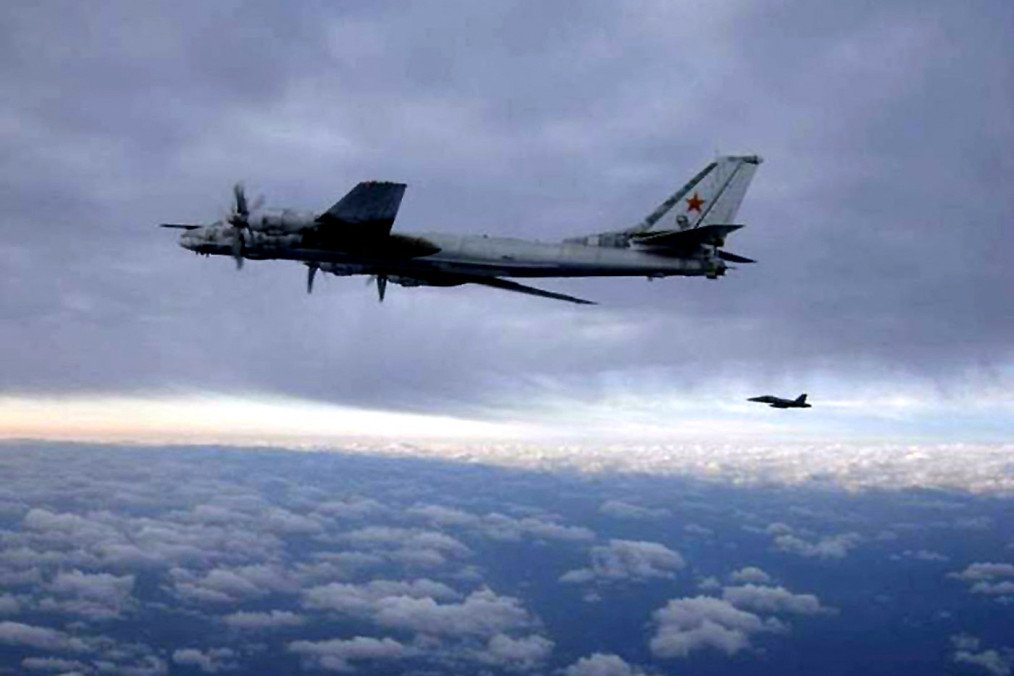 A US Navy F/A-18 Hornet intercepts a Russian Tu-95 strategic bomber near the USS Nimitz south of Japan. (Source: Getty Images)