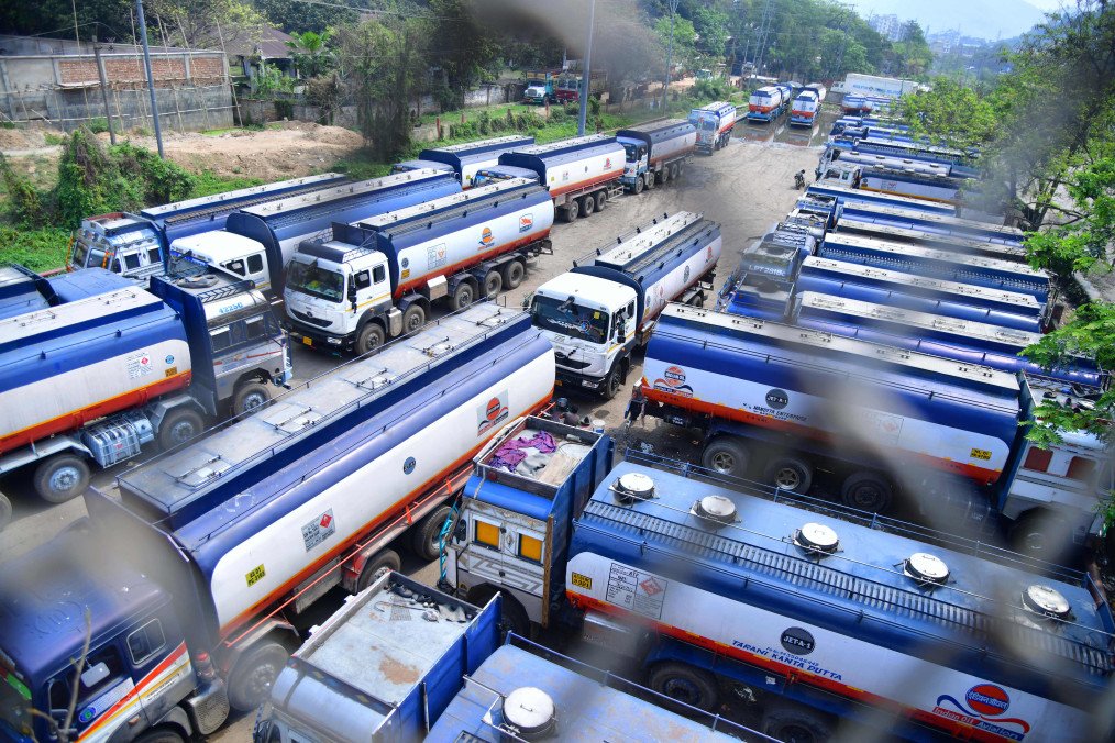 Trucks wait outside the Guwahati Refinery operated by Indian Oil Corporation, in Guwahati on March 30, 2023. (Source: Getty Images)
