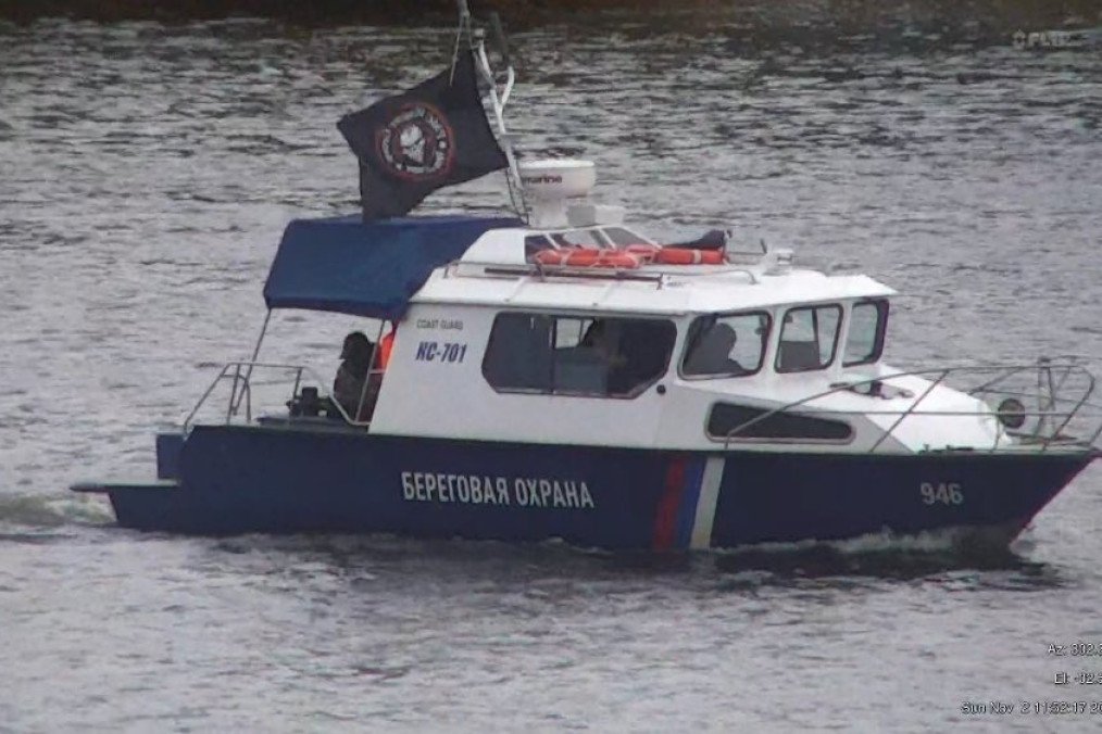 Russian FSB coast guard boat patrols the Narva River near the Estonian border while flying a Wagner Group flag. (Source: Estonian MFA)