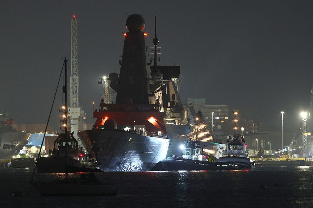 A tug boat accompanies HMS Dragon in the docks at HMNB Portsmouth on March 3, 2026 in Portsmouth, England. (Source: Getty Images)