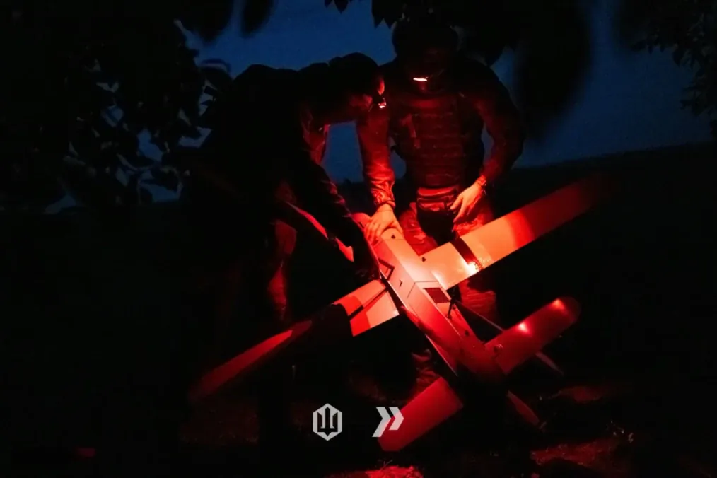 Ukrainian operators prepare a long-range drone for a night mission under tactical red lighting. (Photo: 413th Separate Unmanned Systems Regiment Raid)