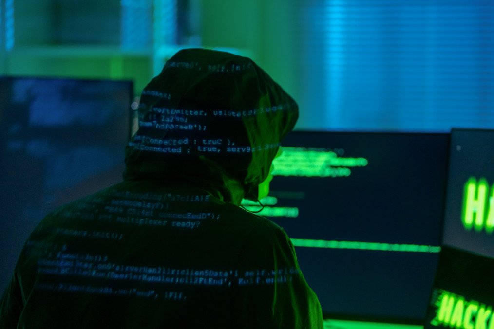 A view of a hooded hacker organizing a massive data breach attack on corporate servers in a dark location. Illustrative photo. (Source: Getty Images)