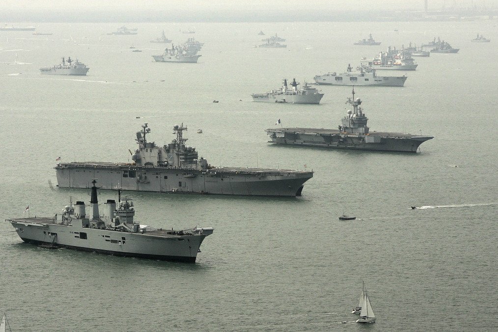 Illustrative image. An aerial view of (L-R) HMS Invincible, USS Saipan, and FS Charles de Gaulle with some of the 112 warships gathered in the Solent ahead of the International Fleet Review on June 26, 2005, in Portsmouth, England. (Source: Getty Images)