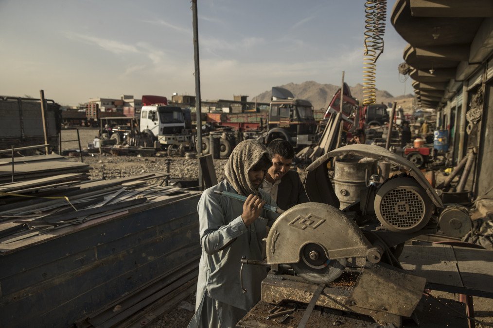 Mechanics work while building transfer trucks at a yard in Kabul, Afghanistan, on Saturday, November 4, 2017. Illustrative image. (Photo: Getty Images)