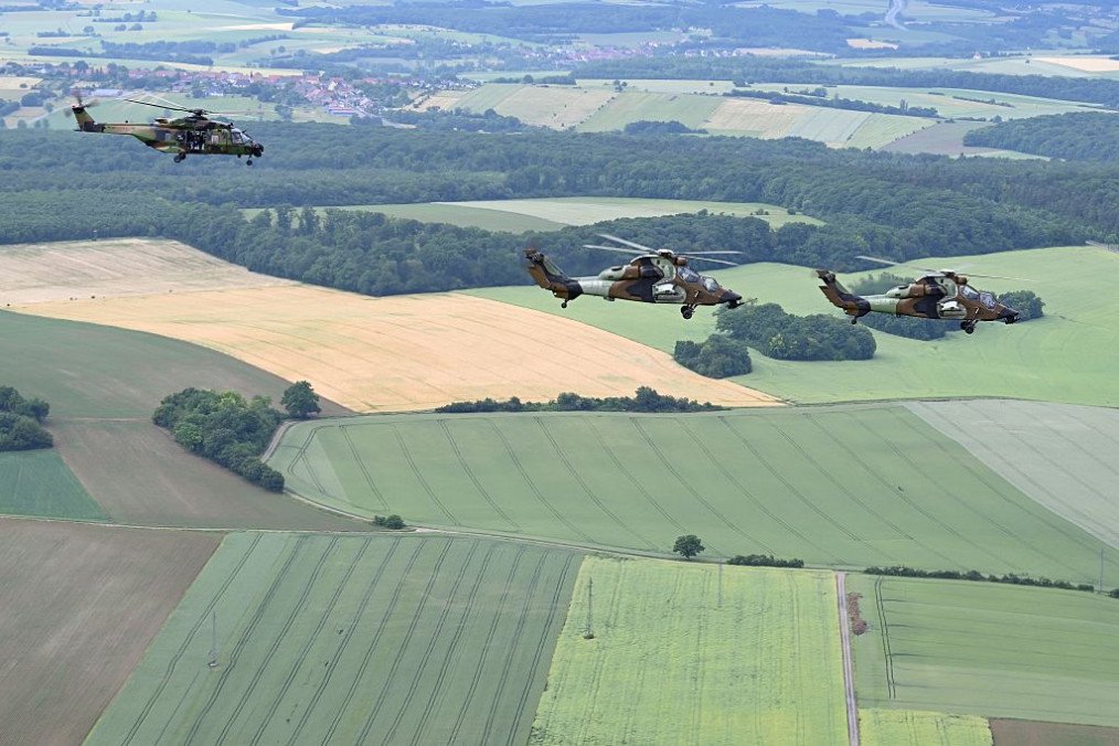 A French Army NH90 Caïman assault helicopter (L) and French Army Tigre attack helicopters (R) take part in a tactical flight over Phalsbourg, north-eastern France on June 2, 2026. (Source: Getty Images)