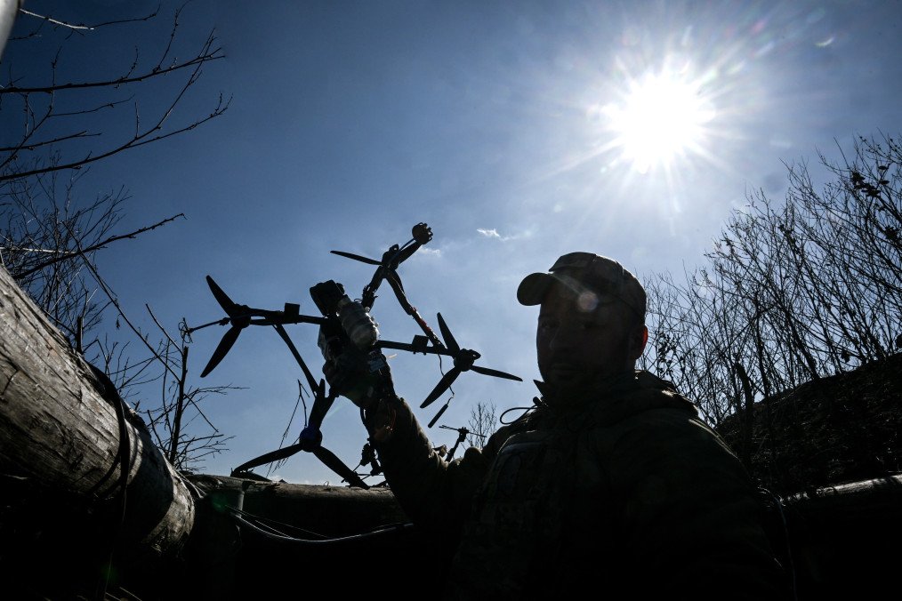 A fighter of the Special Purpose Police Battalion of the Main Directorate of the National Police in Zaporizhzhia region launches an FPV drone from a trench on the approaches to Zaporizhzhia, Ukraine, on March 5, 2026. (Source: Getty Images)