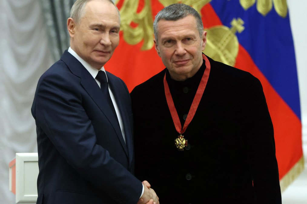 Russian leader Vladimir Putin (L) congratulates television propagandist Vladimir Solovyov (R) during an award ceremony at the Kremlin, on December 24, 2025, in Moscow, Russia.