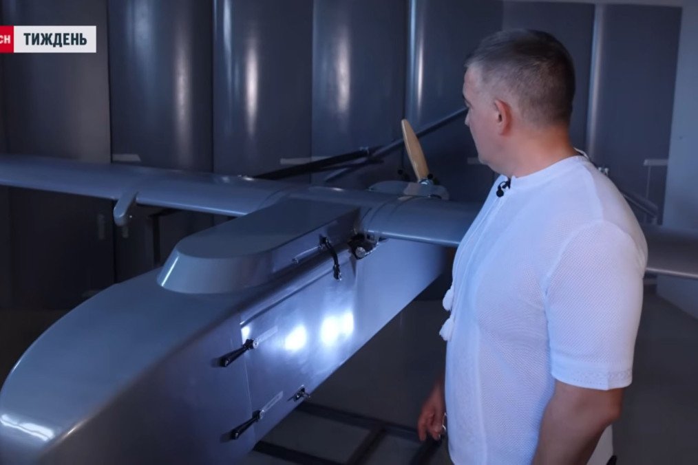 Denys Shtilerman stands beside a Ukrainian FP-1 long-range strike drone, May 2026. (Source: TSN)