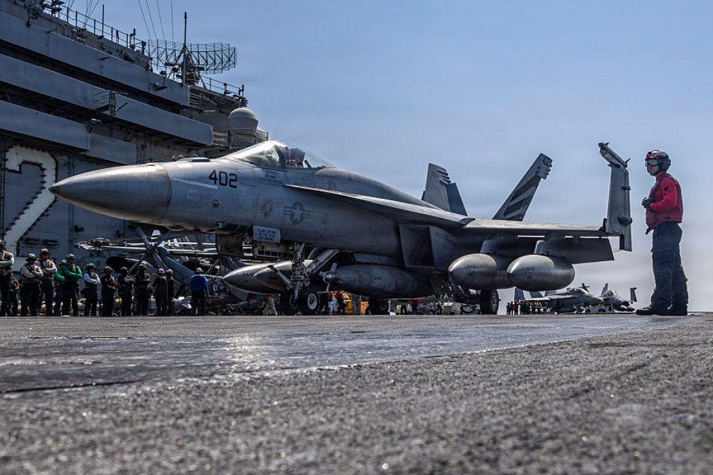An F/A-18E Super Hornet, attached to Strike Fighter Squadron (VFA) 151, taxis the flight deck of the Nimitz-class aircraft carrier USS Abraham Lincoln (CVN 72) in support of Operation Epic Fury on March 2, 2026. (Source: Getty Images)