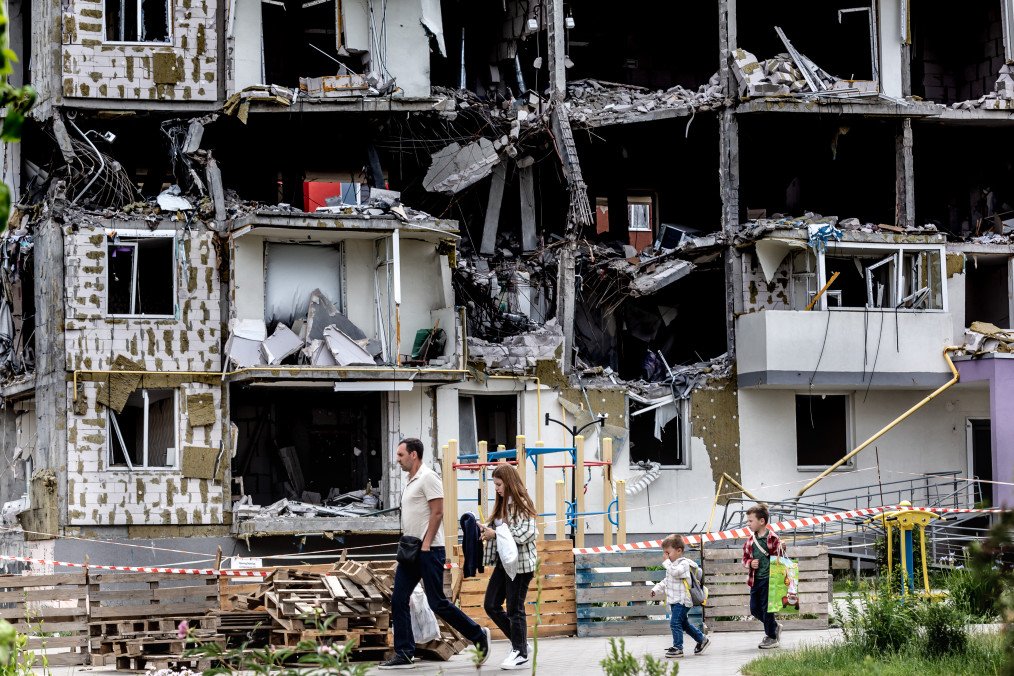 A family walks in a residential area affected by bombardment on June 14, 2022 in Bucha, Ukraine. (Source: Getty Images)