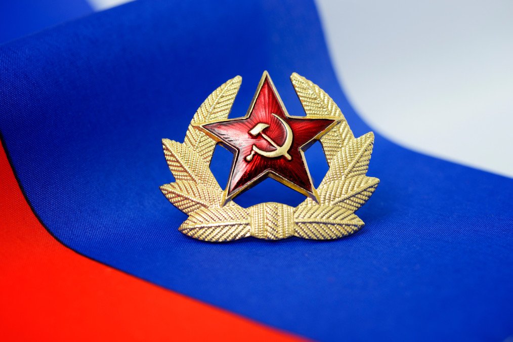 Soviet symbols against the background of the Russian flag. (Source: Getty Images)