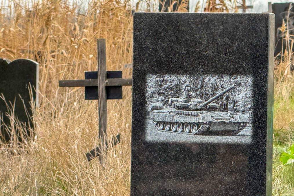 Black granite tombstone with an engraved russian tank in a cemetery, Donetsk region, Mariupol, Ukraine, on November 24, 2025. Black granite tombstone with an engraved russian tank in a cemetery, Donetsk region, Mariupol, Ukraine, on November 24, 2025.
