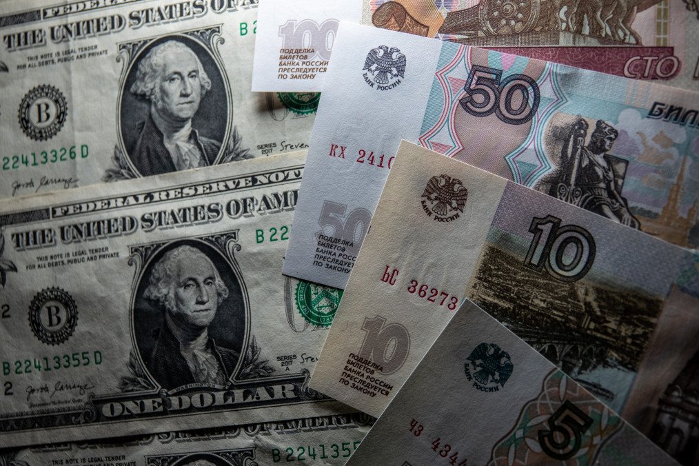 Russia Sets New Military Spending Record at $142.25B as War Costs Climb to $20.9M Per Hour for Moscow In this photo illustration, Russian rouble notes are seen besides one Dollar bill notes on January 11, 2025 in Bath, England. Illustrative photo. (Source: Getty Images)