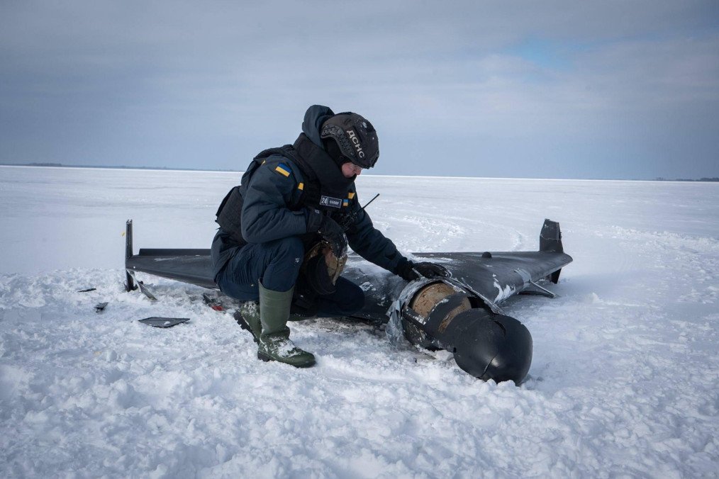 A Ukrainian emergency worker inspects the wreckage of a downed Russian Shahed-type drone in the Chernihiv region. (Source: DSNS Chernihiv)