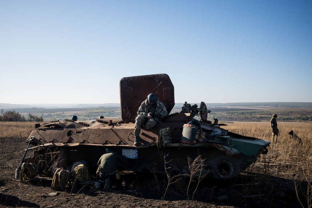 A volunteer searches a battlefield near the wreckage of a Russian armored personnel carrier in Ukraine's Donetsk region. (Source: Getty Images) A volunteer searches a battlefield near the wreckage of a Russian armored personnel carrier in Ukraine's Donetsk region. (Source: Getty Images)