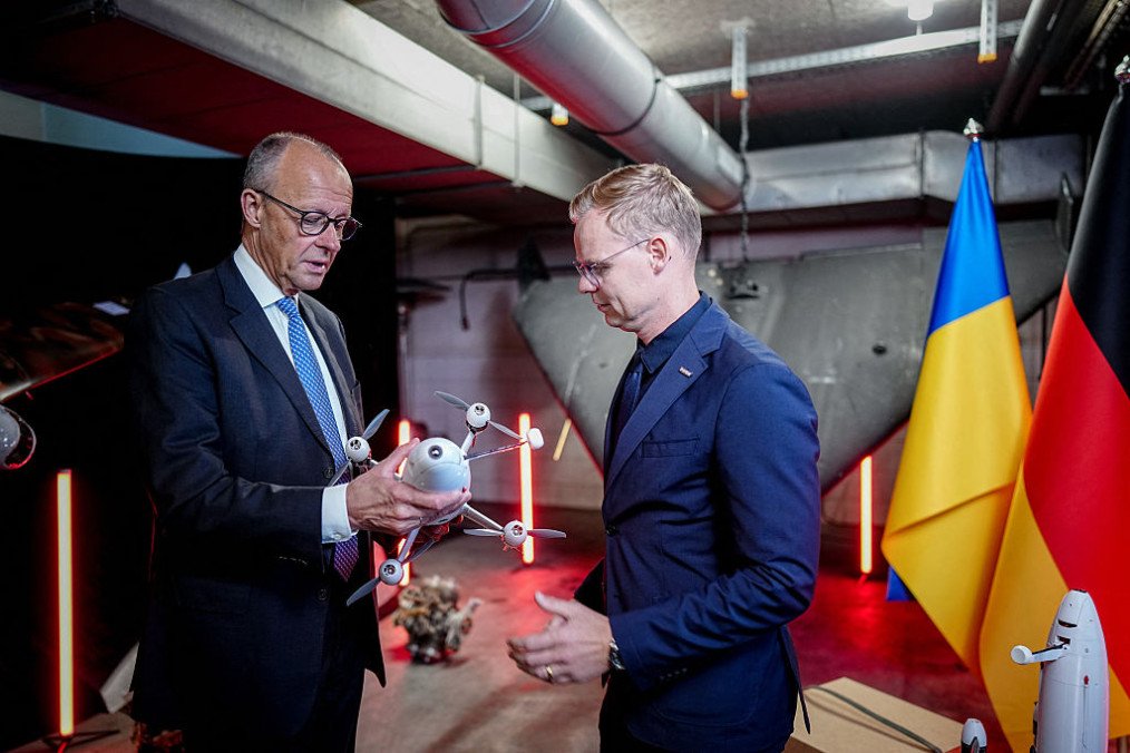 German Chancellor Friedrich Merz inspects the “Spys” jet fighter interceptor drone developed in Ukraine by Quantum WIY Industries in Kyiv, alongside Quantum CEO Sven Kruck. (Source: Getty Images)