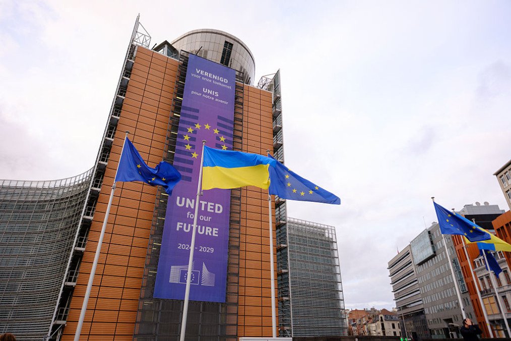 EU and Ukrainian flags fly in the wind in front of the Berlaymont, the EU Commission headquarter for the 4th year anniversary of the full scale invasion of Ukraine by Russia, on February 23, 2025 in Brussels, Belgium. (Source: Getty Images)