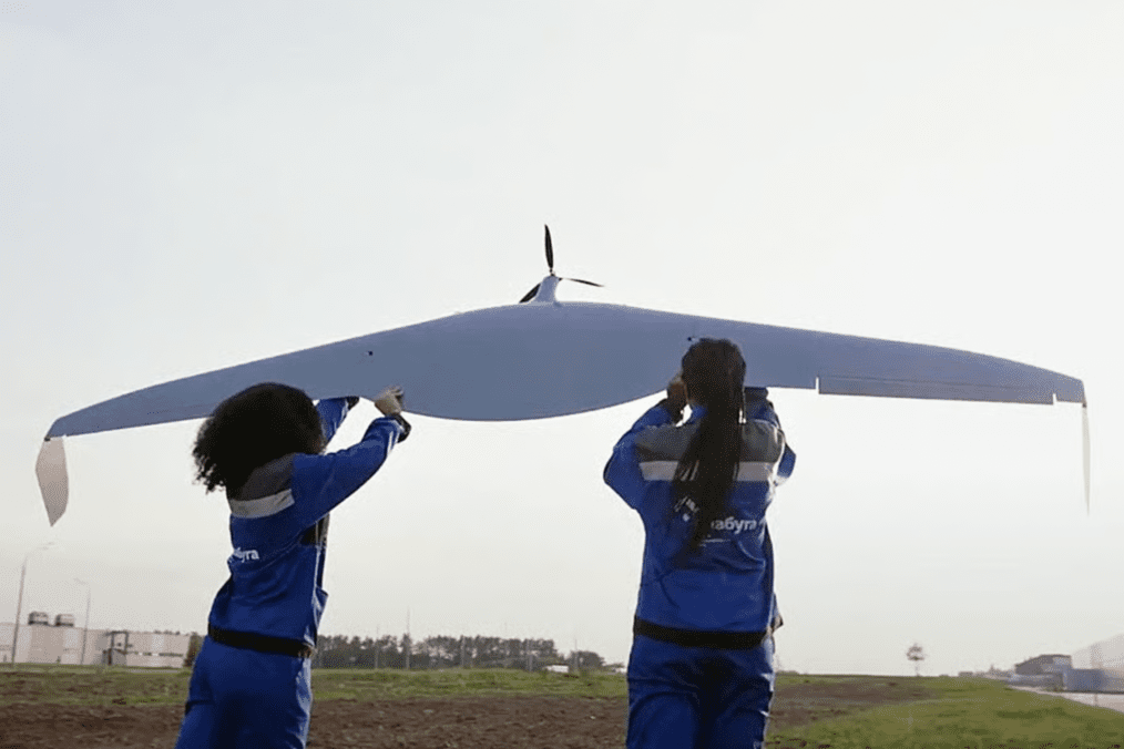 Two workers stand next to a drone airframe in a still frame from an Alabuga youth recruitment video on YouTube. Two workers stand next to a drone airframe in a still frame from an Alabuga youth recruitment video on YouTube.