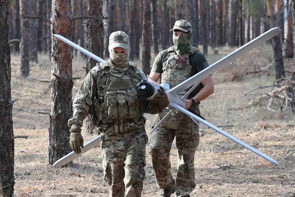 Russian troops carry a Lancet loitering munition during preparations for combat deployment. (Source: Russian media)