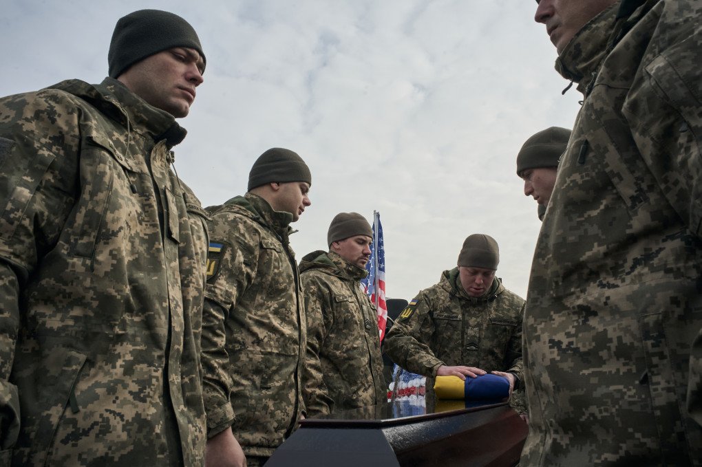 Handing over the Flag of Ukraine on behalf of the President of Ukraine to the parents of the deceased soldier attend as Ukraine pays tribute to the fallen American citizen US Marine Corps veteran Ethan Hertweck fighting for the Ukrainian army during his funeral on February 28 in Kyiv, Ukraine. (Photo by Kostiantyn Liberov/Libkos/Getty Images) Handing over the Flag of Ukraine on behalf of the President of Ukraine to the parents of the deceased soldier attend as Ukraine pays tribute to the fallen American citizen US Marine Corps veteran Ethan Hertweck fighting for the Ukrainian army during his funeral on February 28 in Kyiv, Ukraine. (Photo by Kostiantyn Liberov/Libkos/Getty Images)